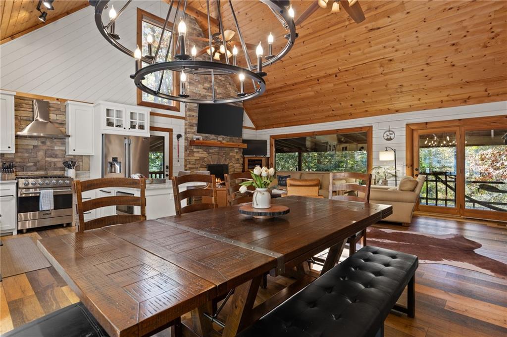454 High Country Lane Morganton, GA 30560 - Photo 54 of 79 a view of a dining room with furniture a chandelier and wooden floor