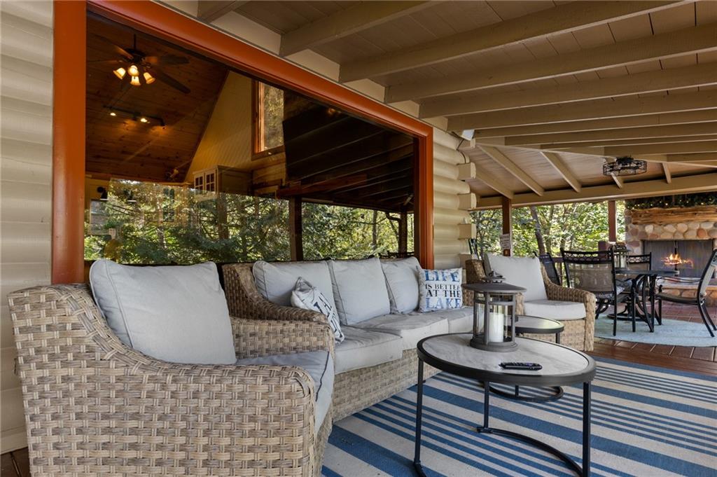 454 High Country Lane Morganton, GA 30560 - Photo 56 of 79 a outdoor space with patio the couches and a dining table with the view of potted plants