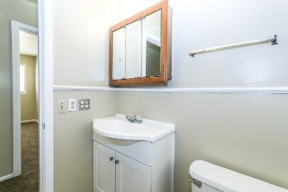 5408 31st Street Lubbock, TX 79407 - Photo 27 of 33 a bathroom with a sink a toilet and mirror
