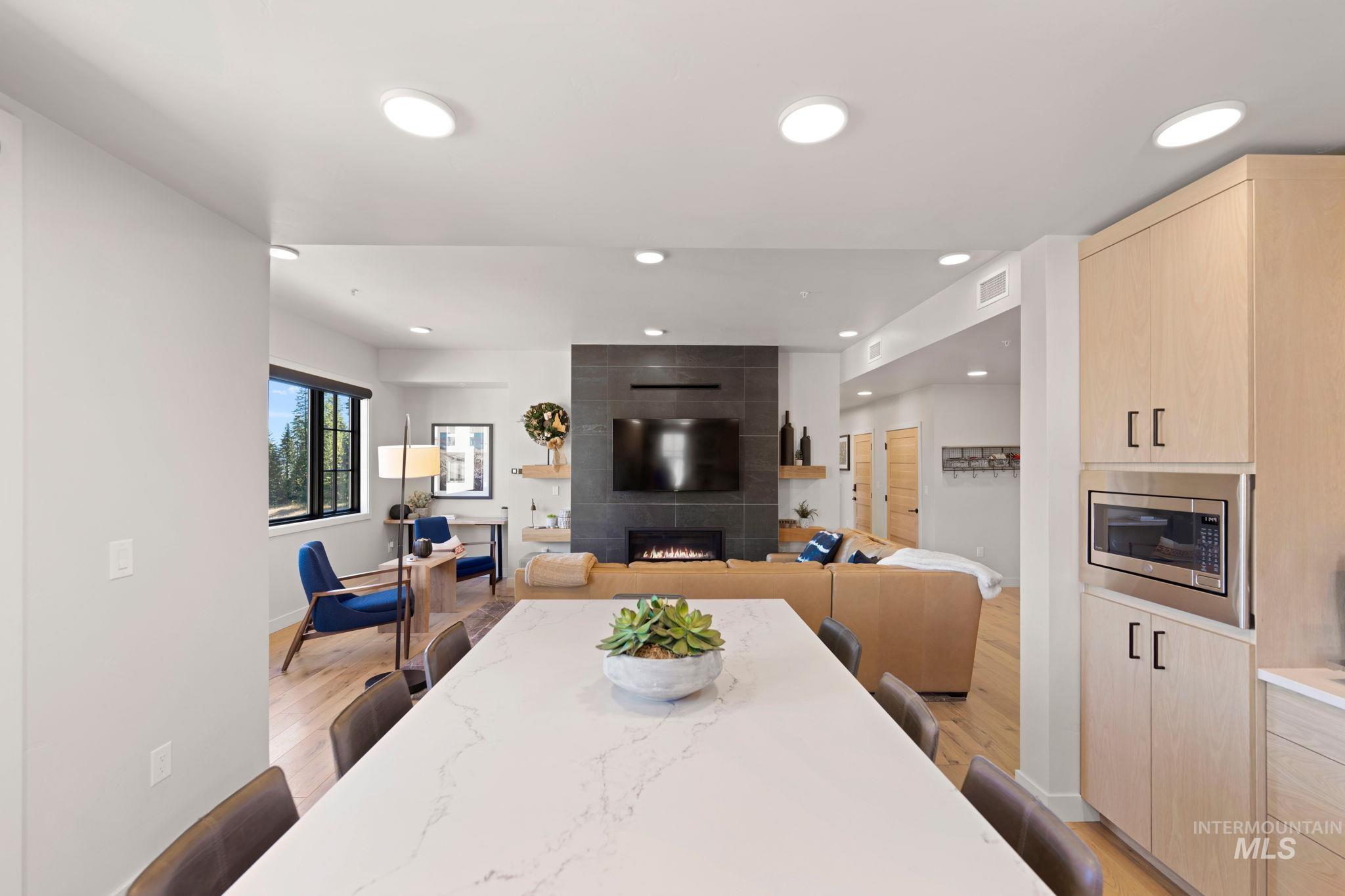 720 Village Drive, Unit 301 Donnelly, ID 83615 - Photo 5 of 43 Dining space with light wood-style floors, a fireplace, and recessed lighting