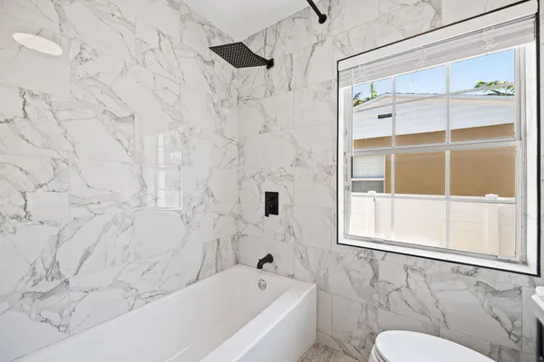 a bathroom with a bathtub and a shower