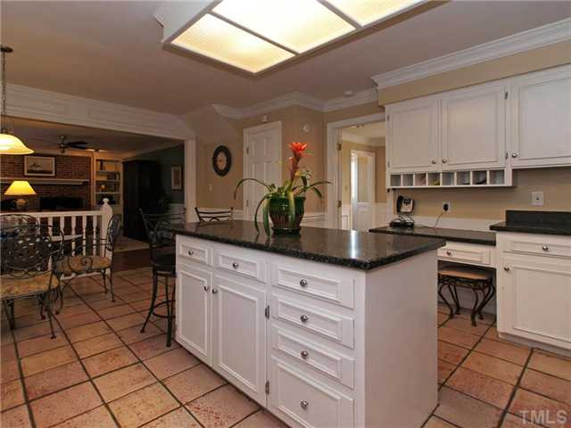8316 Apple Orchard Way Raleigh, NC 27615 - Photo 5 of 25 Kitchen features an island with storage and desk. Hurry! Kitchen