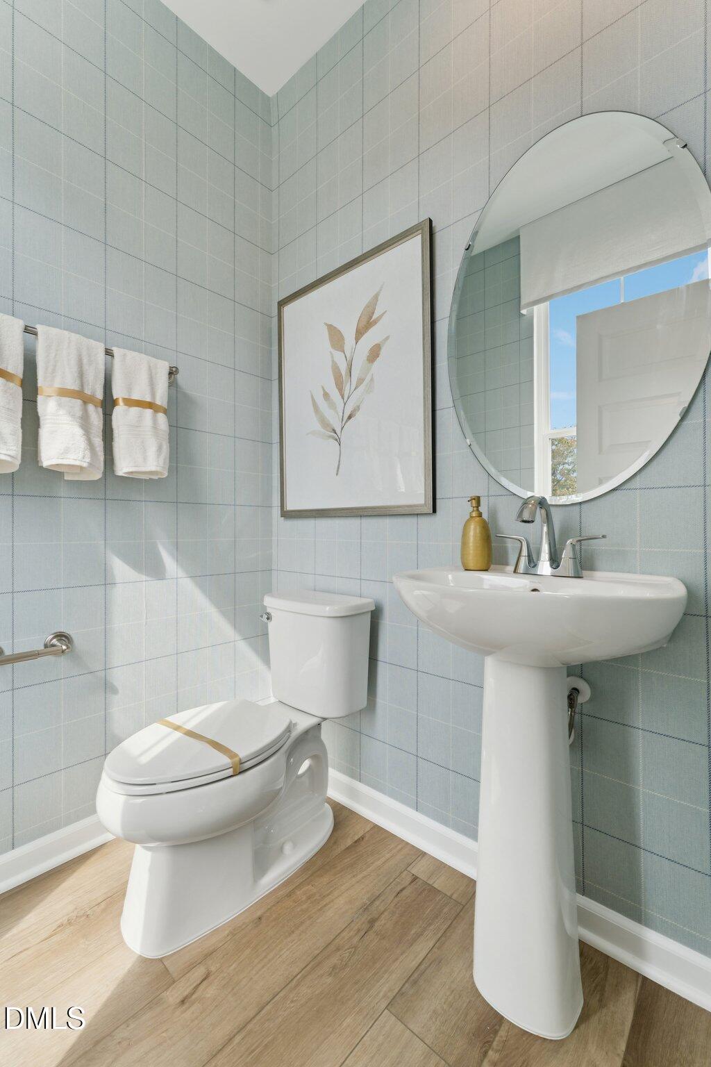 3202 Bomore Road Raleigh, NC 27610 - Photo 12 of 35 a bathroom with a toilet sink and mirror
