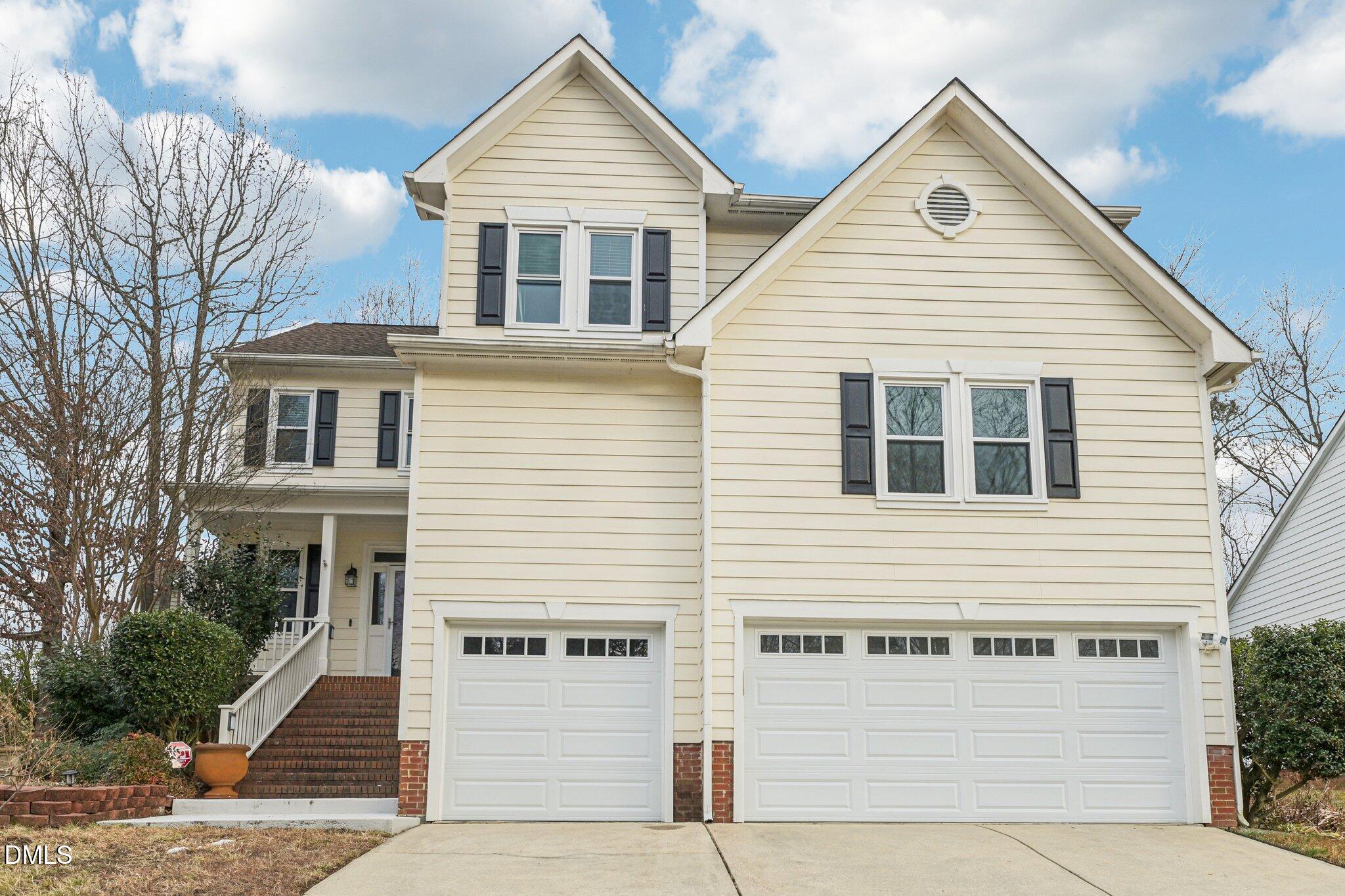 a view of a white house with large windows