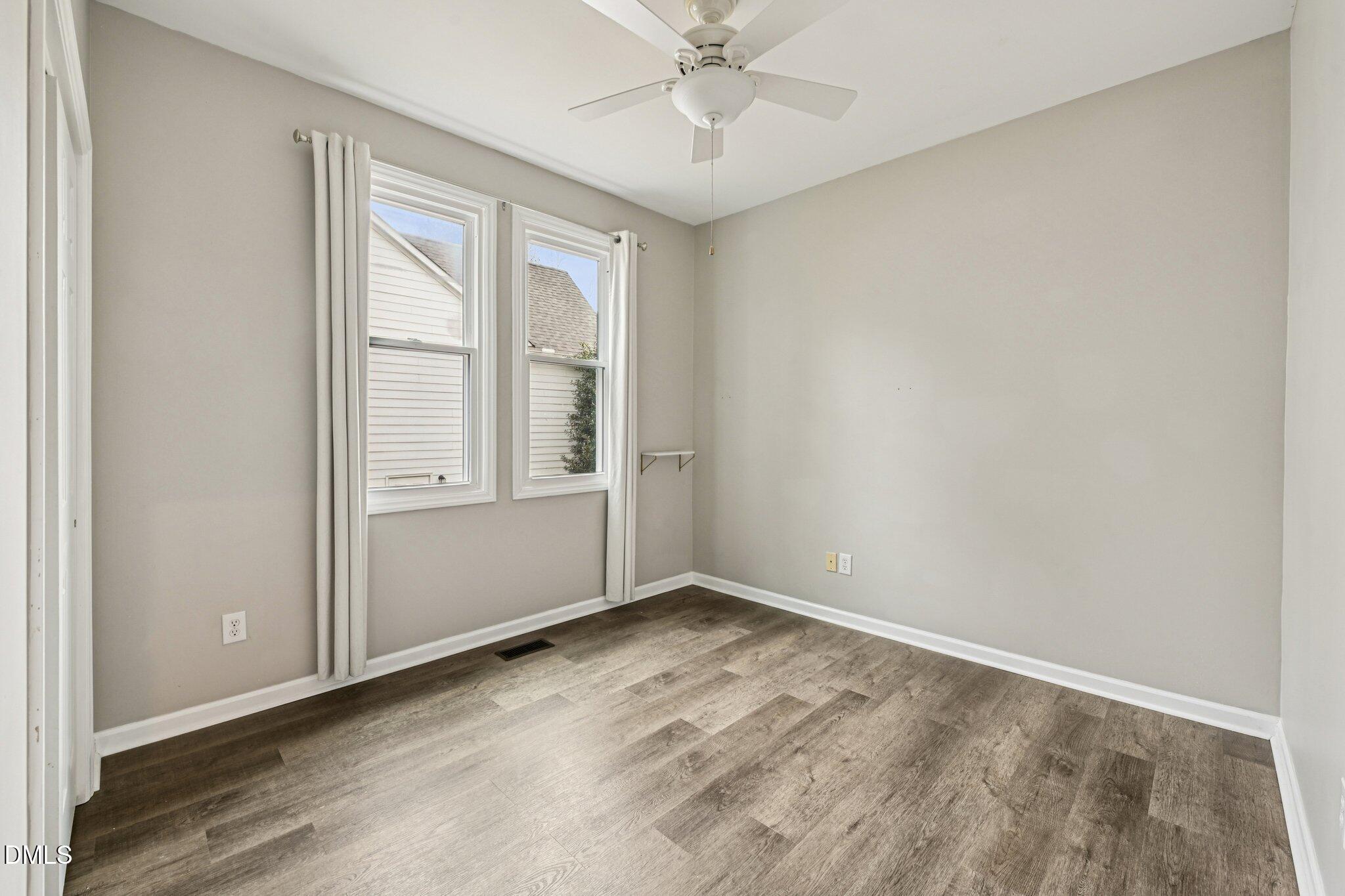13100 Townfield Drive Raleigh, NC 27614 - Photo 12 of 31 an empty room with chandelier fan and windows