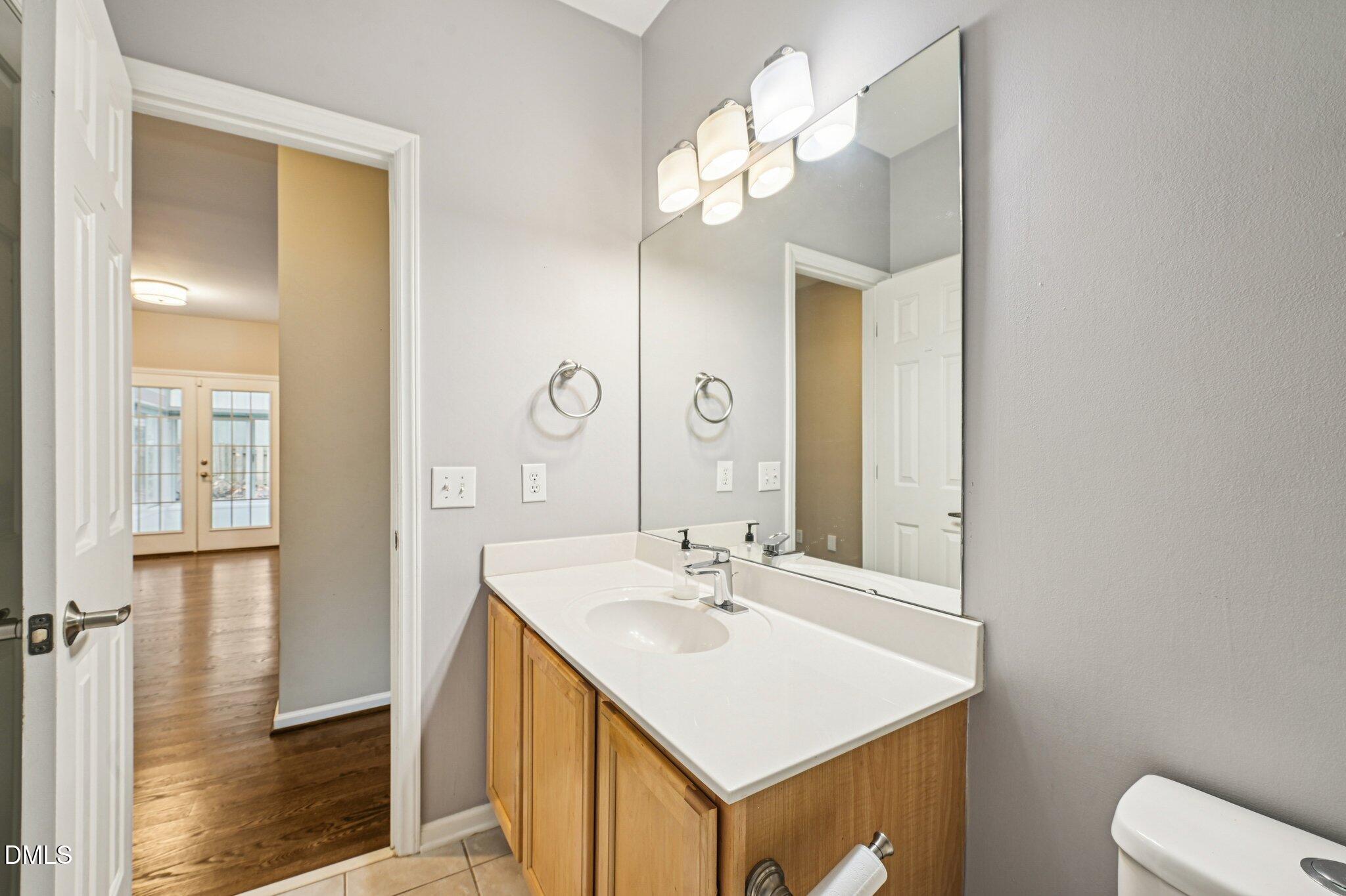 13100 Townfield Drive Raleigh, NC 27614 - Photo 13 of 31 a bathroom with a sink a light fixture and a mirror