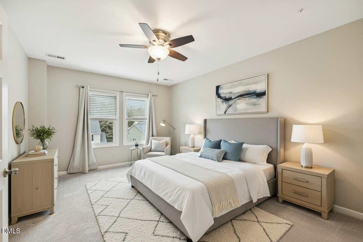 13100 Townfield Drive Raleigh, NC 27614 - Photo 14 of 31 a bedroom with a large bed and a chandelier