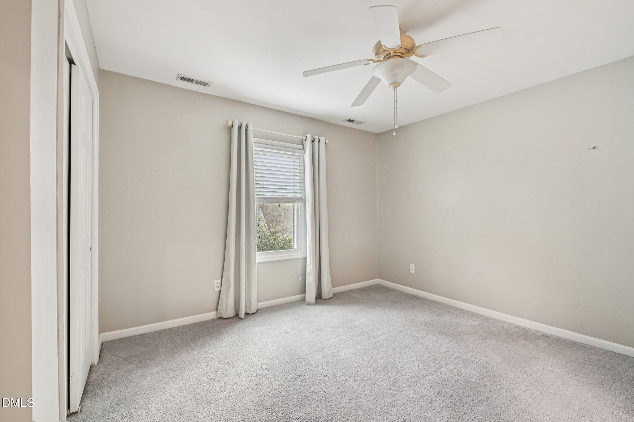 13100 Townfield Drive Raleigh, NC 27614 - Photo 15 of 31 an empty room with windows and fan