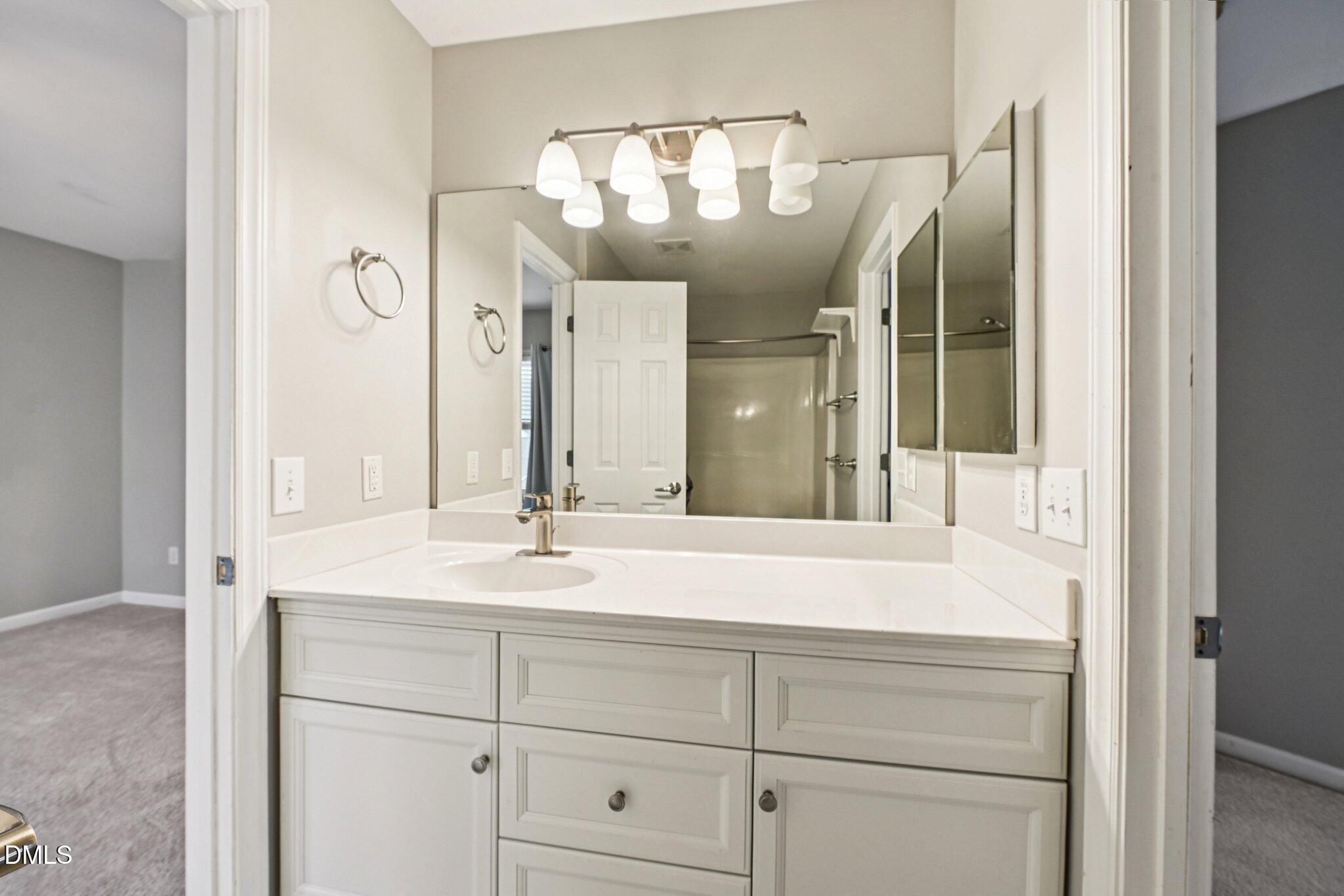 13100 Townfield Drive Raleigh, NC 27614 - Photo 16 of 31 a bathroom with a sink and a mirror