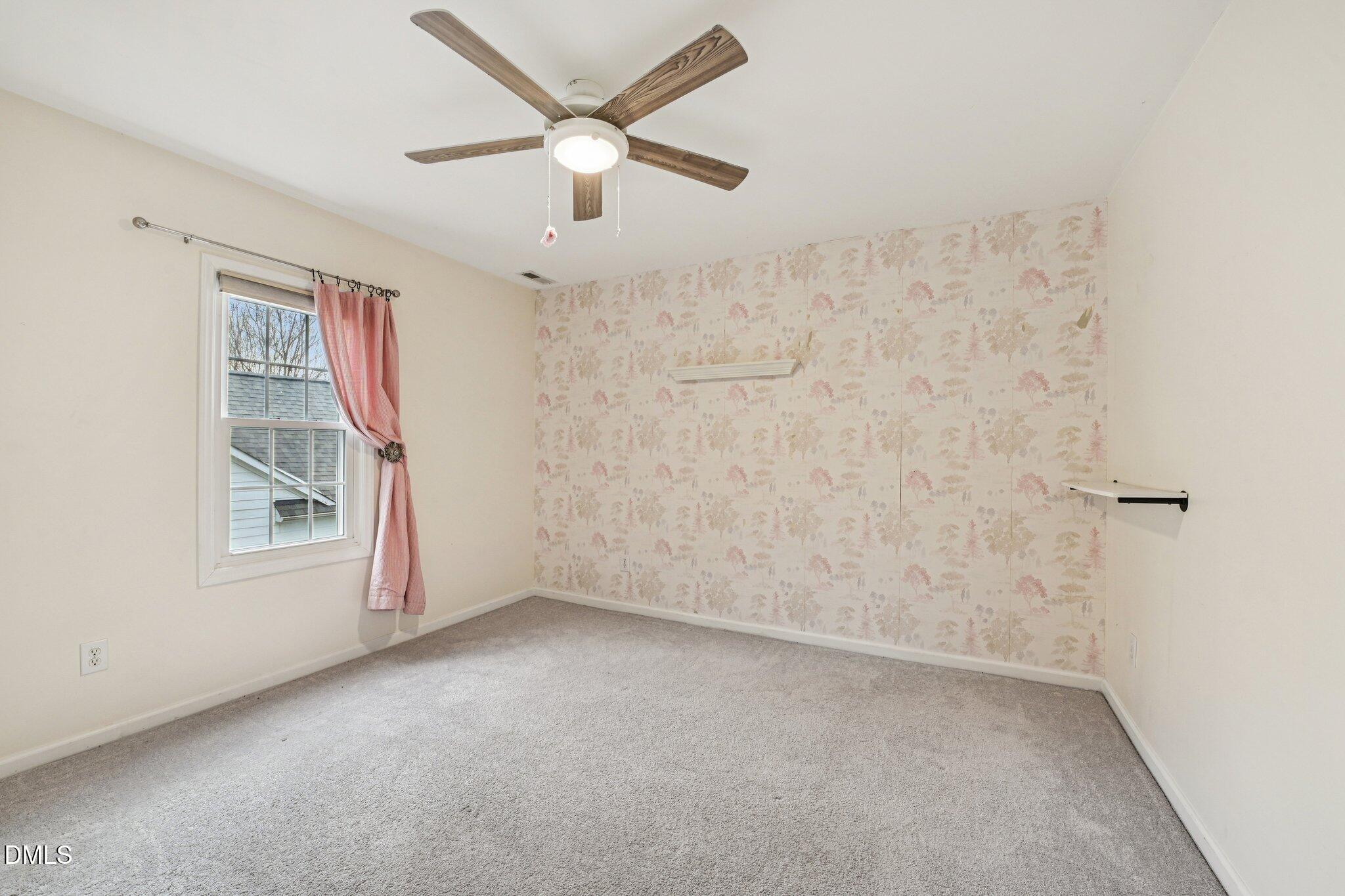 13100 Townfield Drive Raleigh, NC 27614 - Photo 19 of 31 an empty room with a window and a fan