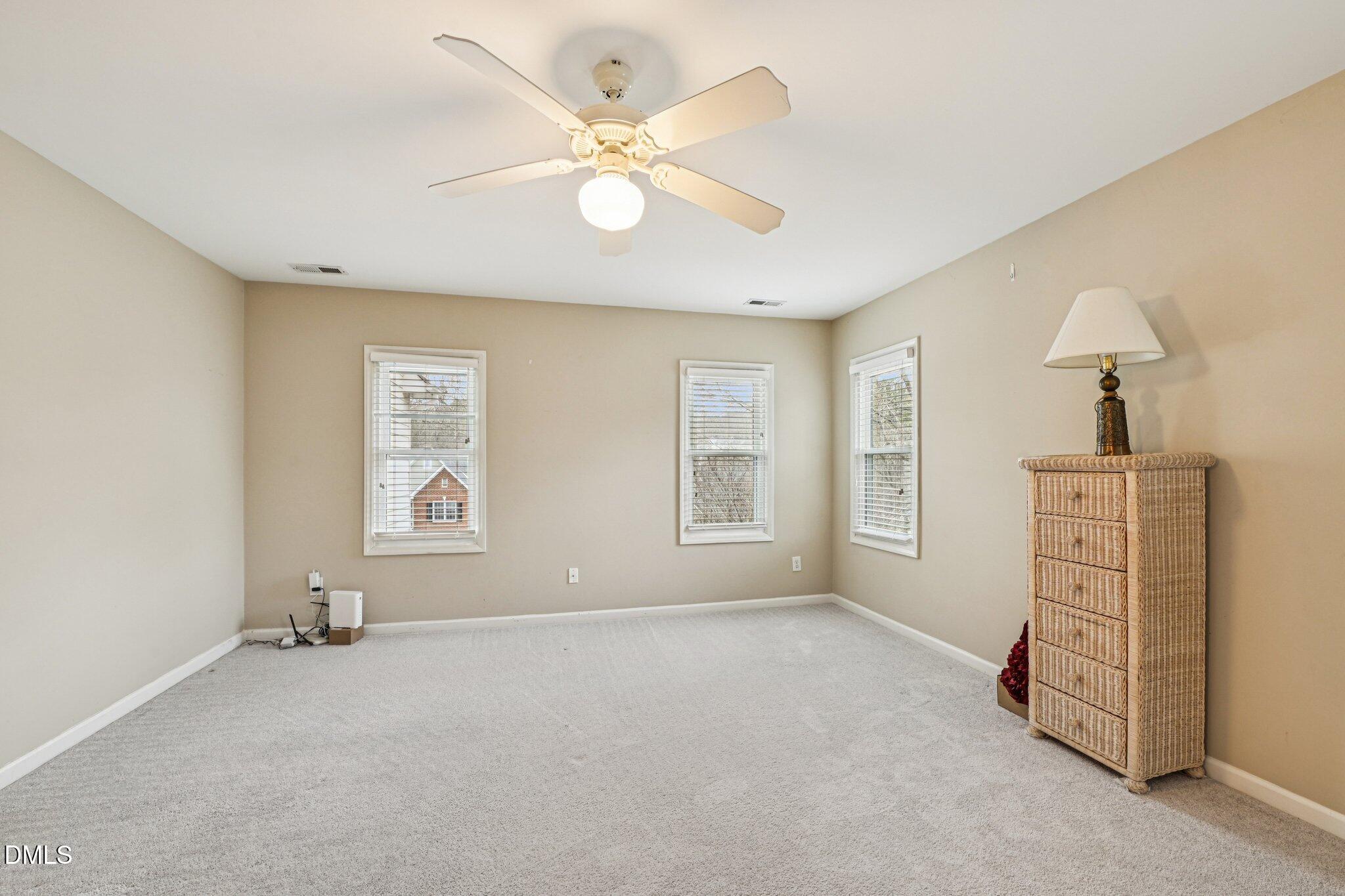 13100 Townfield Drive Raleigh, NC 27614 - Photo 21 of 31 an empty room with windows and fan