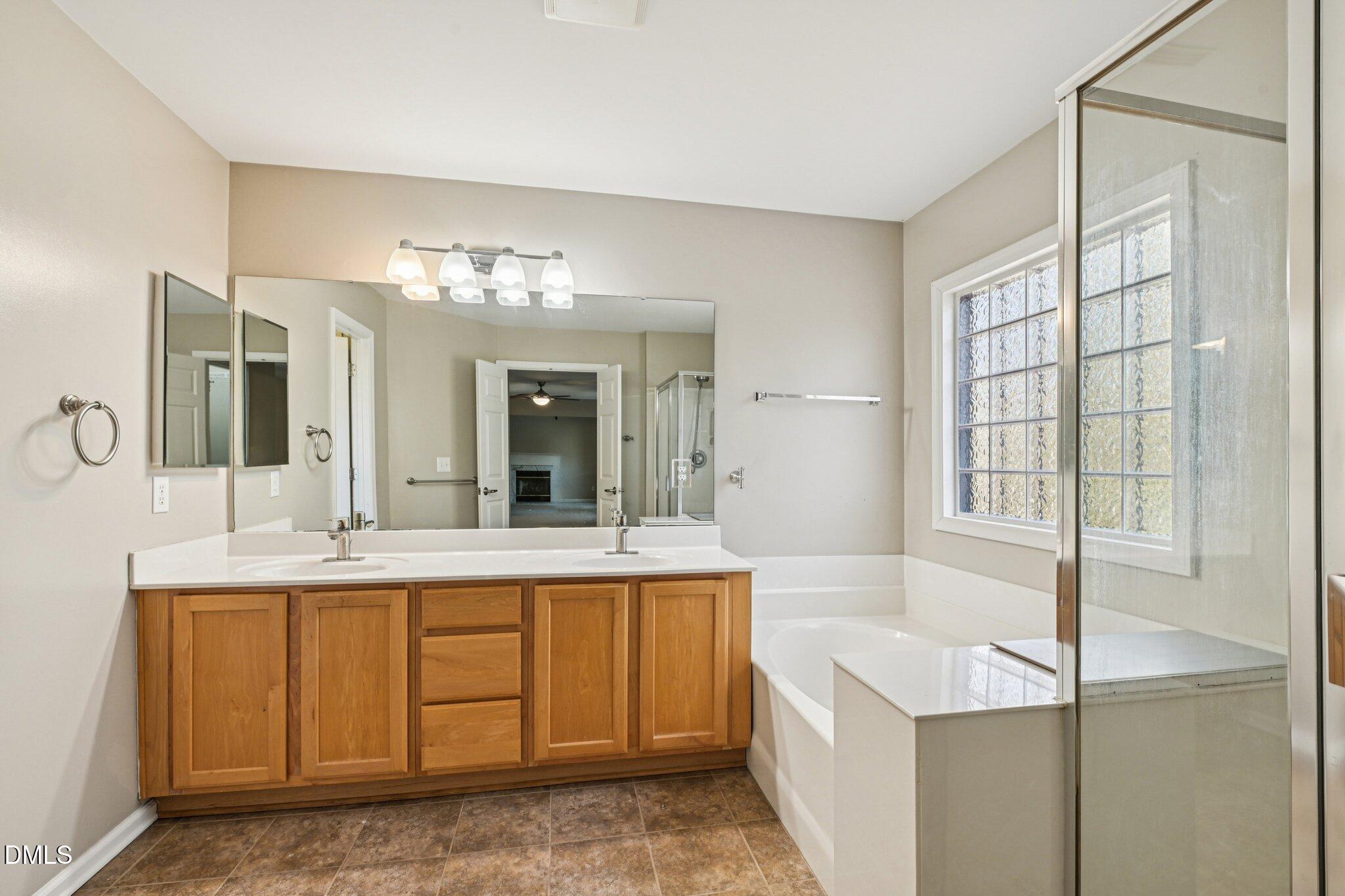 13100 Townfield Drive Raleigh, NC 27614 - Photo 25 of 31 a bathroom with a tub sink and mirror