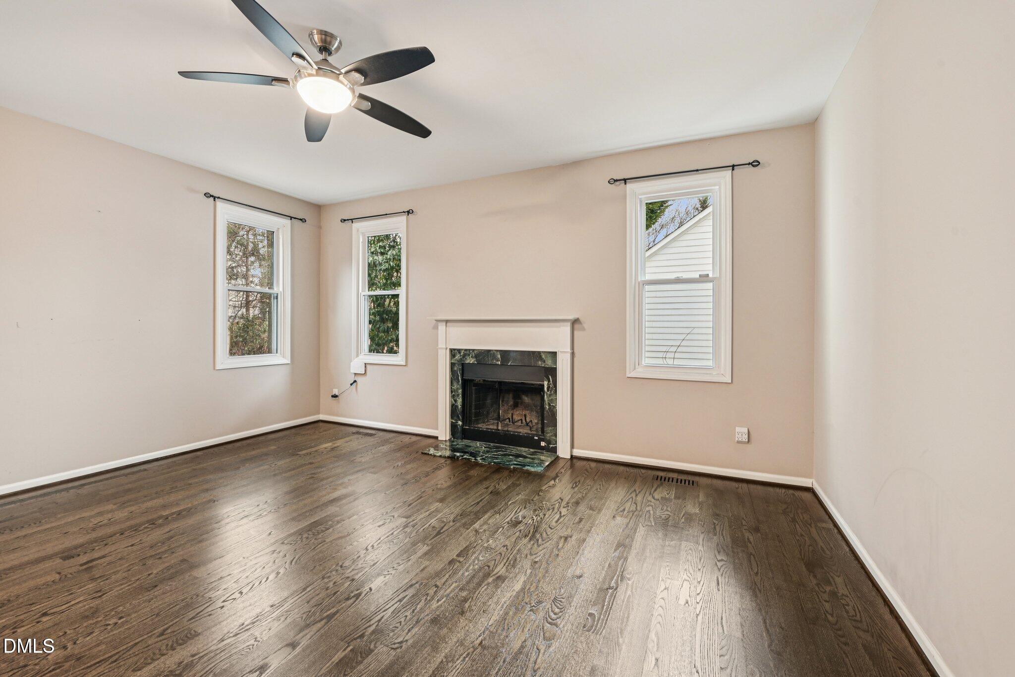 13100 Townfield Drive Raleigh, NC 27614 - Photo 5 of 31 a view of an empty room with a window and wooden floor