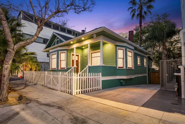 a front view of a house with a garden