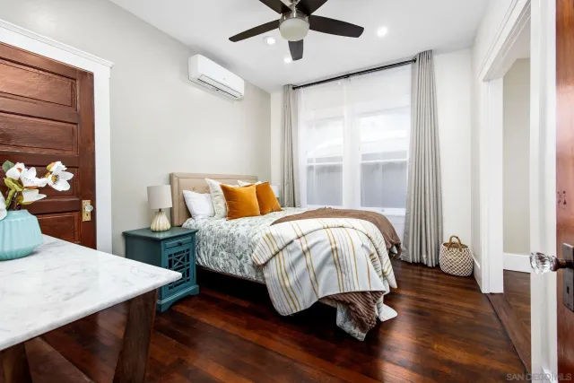 a bedroom with a bed and wooden floor