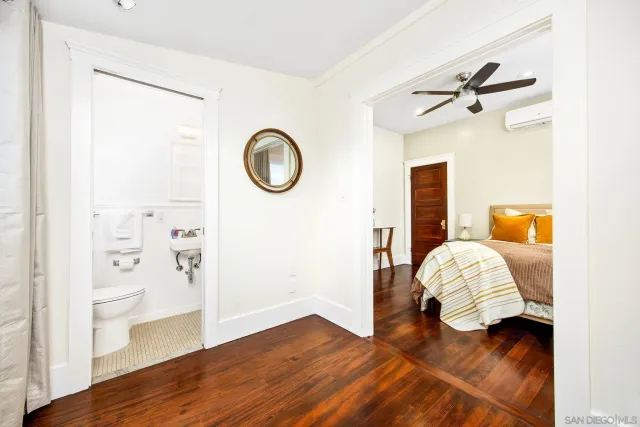 a view of a bedroom with wooden floor