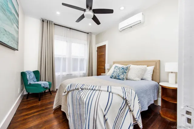 a bedroom with a bed and a chandelier