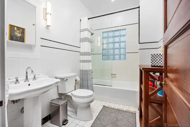 a bathroom with a toilet sink and shower