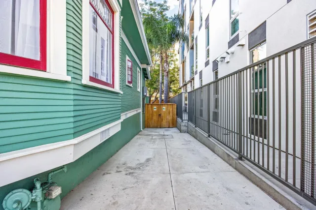 a view of a backyard with a chair and potted plants