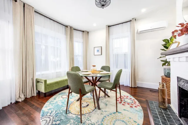 a view of a dining room with furniture and wooden floor