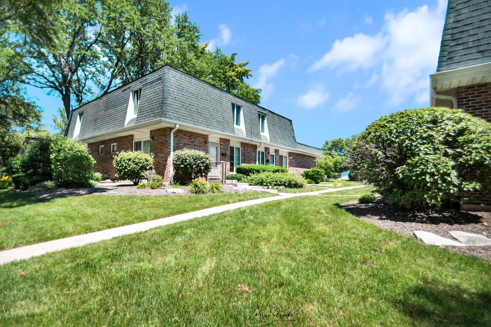 417 Sunnybrook Lane Wheaton, IL 60187 - Photo 2 of 17 a front view of a house with a yard