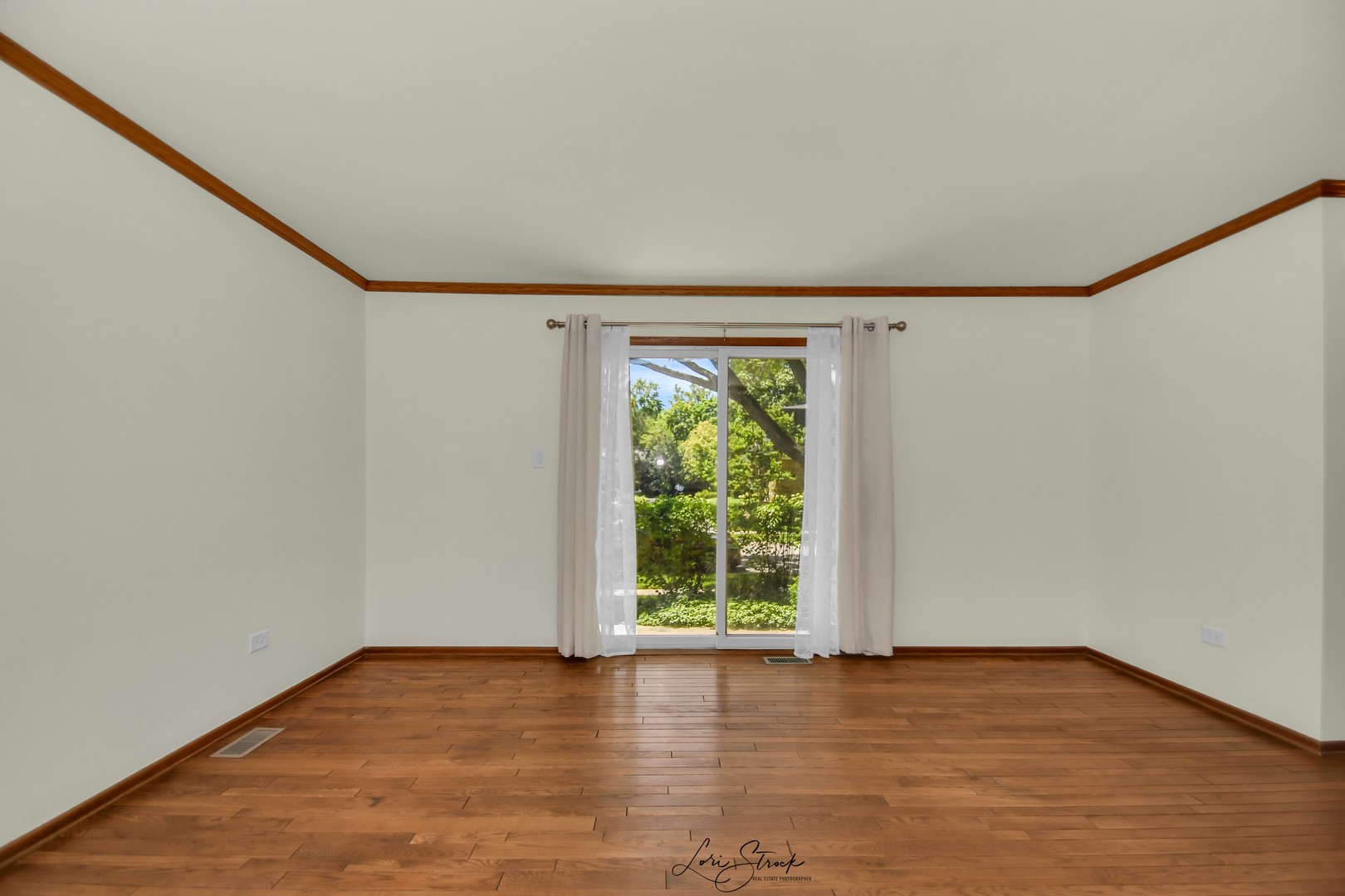 417 Sunnybrook Lane Wheaton, IL 60187 - Photo 6 of 17 a view of an empty room with wooden floor and a window