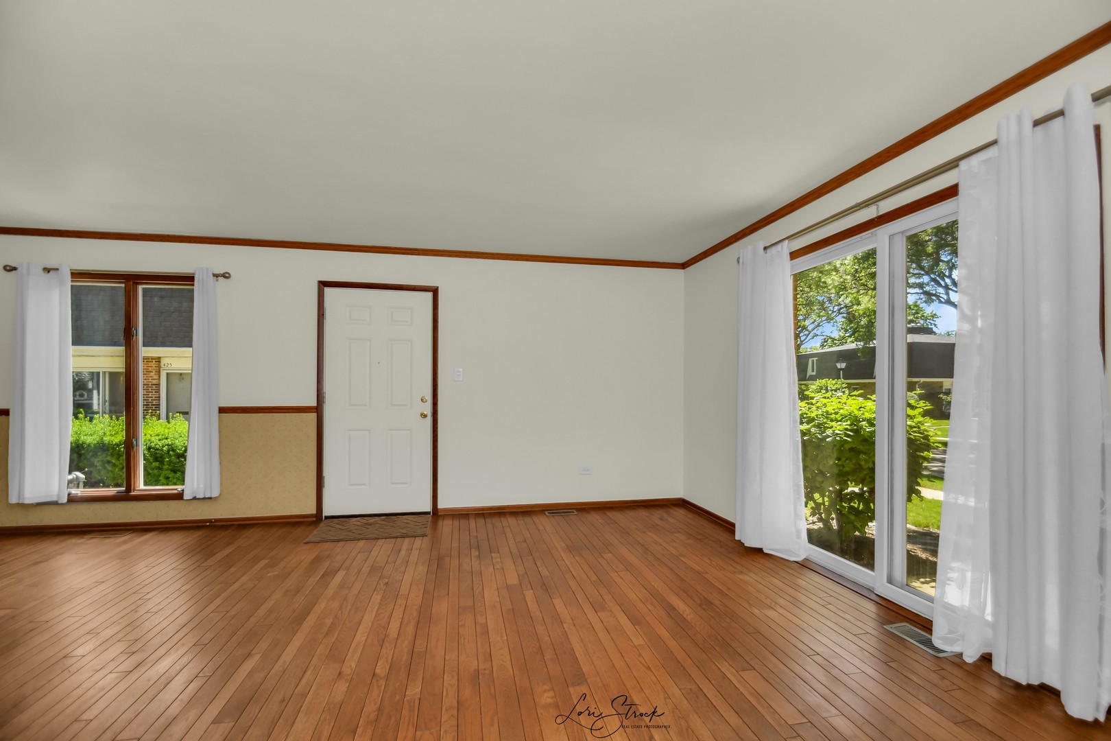 417 Sunnybrook Lane Wheaton, IL 60187 - Photo 7 of 17 a view of an empty room with wooden floor and a window