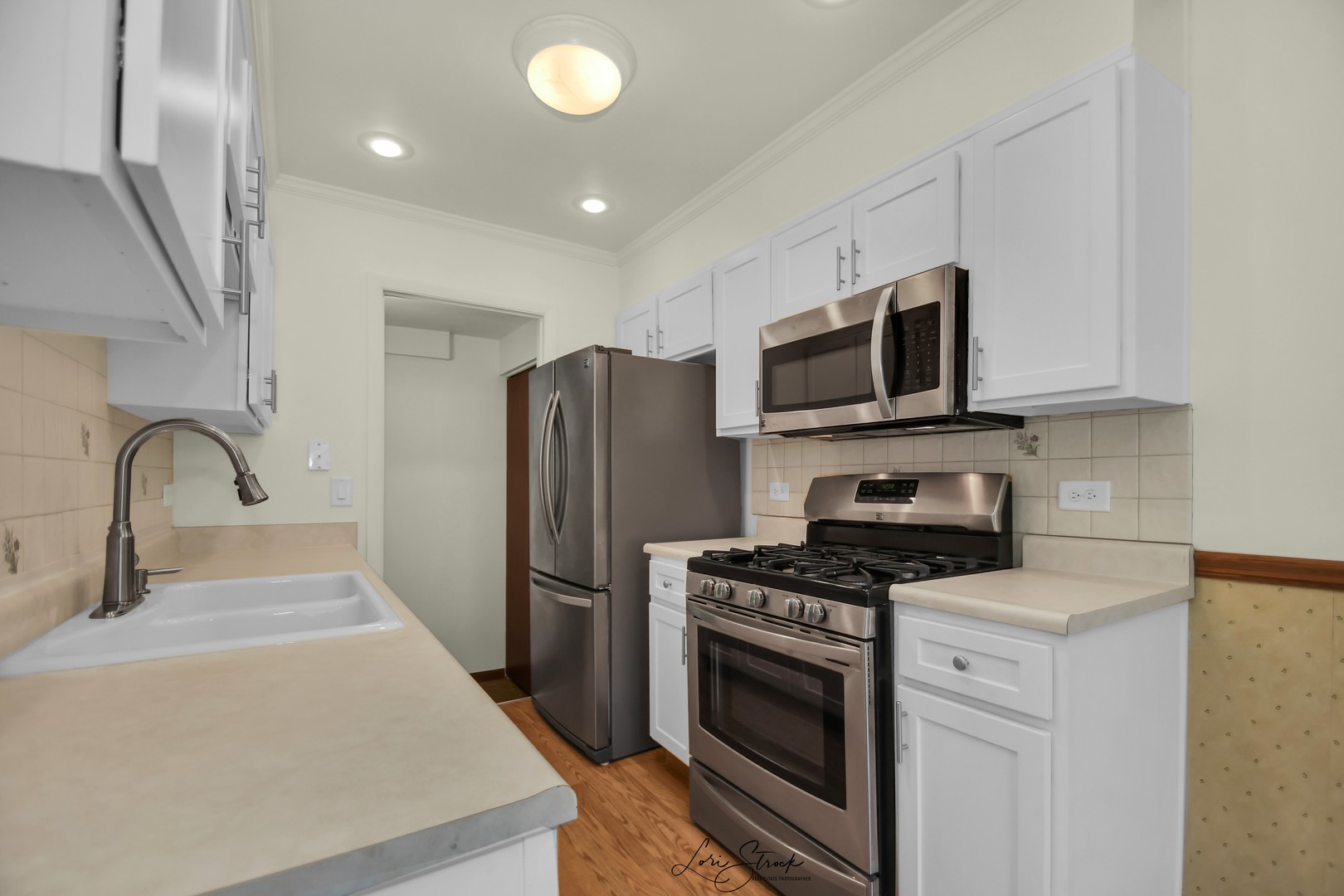 417 Sunnybrook Lane Wheaton, IL 60187 - Photo 9 of 17 a kitchen with stainless steel appliances a stove microwave and a sink