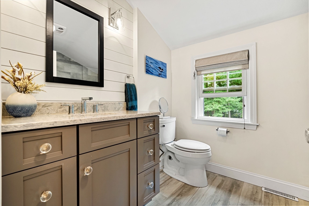 1 Valley Path Marshfield, MA 02050 - Photo 20 of 28 a bathroom with a granite countertop toilet sink and mirror