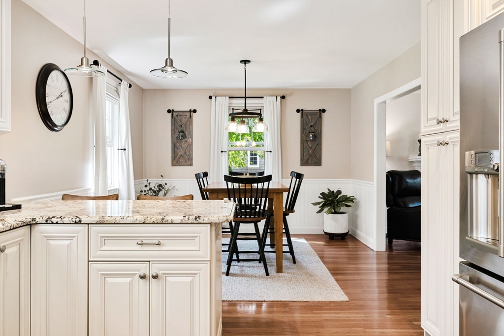 1 Valley Path Marshfield, MA 02050 - Photo 5 of 28 a dining hall with stainless steel appliances kitchen island granite countertop a dining table chairs and a window