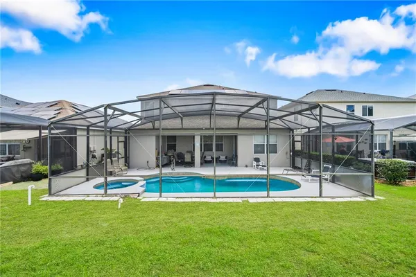 a view of a house with a yard patio and fire pit