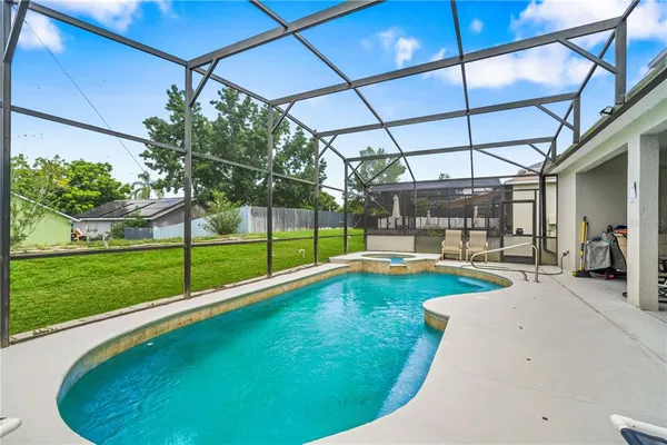 a view of a backyard with a swimming pool