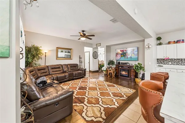 a living room with furniture a couch and a flat screen tv