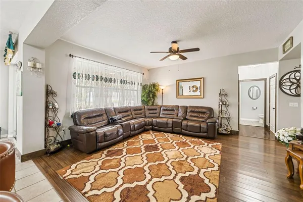 a living room with furniture and wooden floor