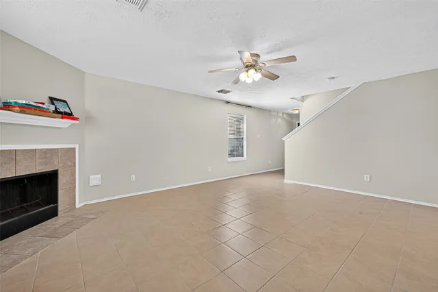an empty room with furniture and a fireplace