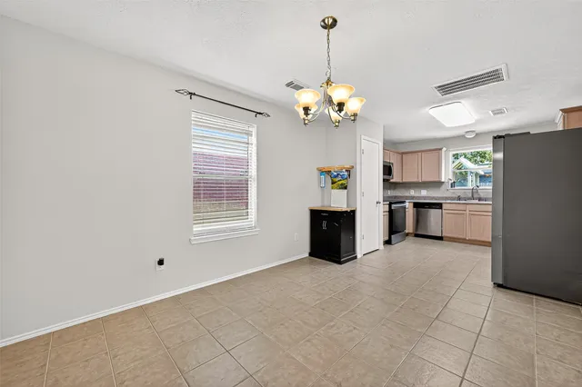 a kitchen with stainless steel appliances granite countertop a refrigerator and a stove top oven