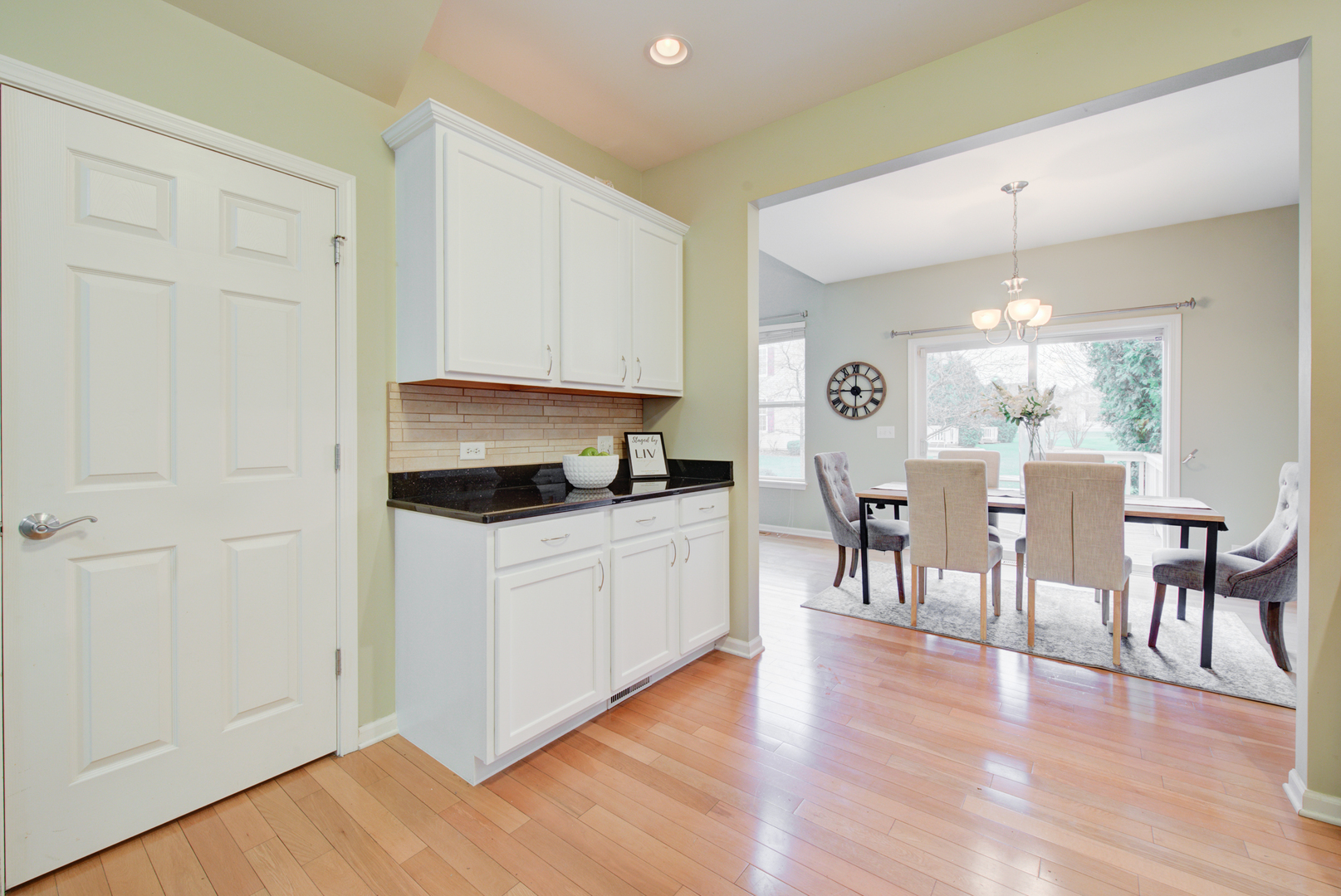 988 Oak Ridge Boulevard Elgin, IL 60120 - Photo 11 of 34 a kitchen with a refrigerator and a dining table