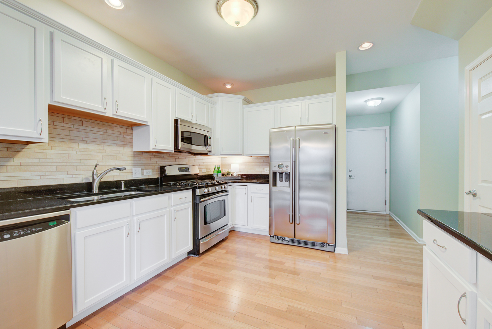 988 Oak Ridge Boulevard Elgin, IL 60120 - Photo 8 of 34 a kitchen with granite countertop a refrigerator sink and cabinets