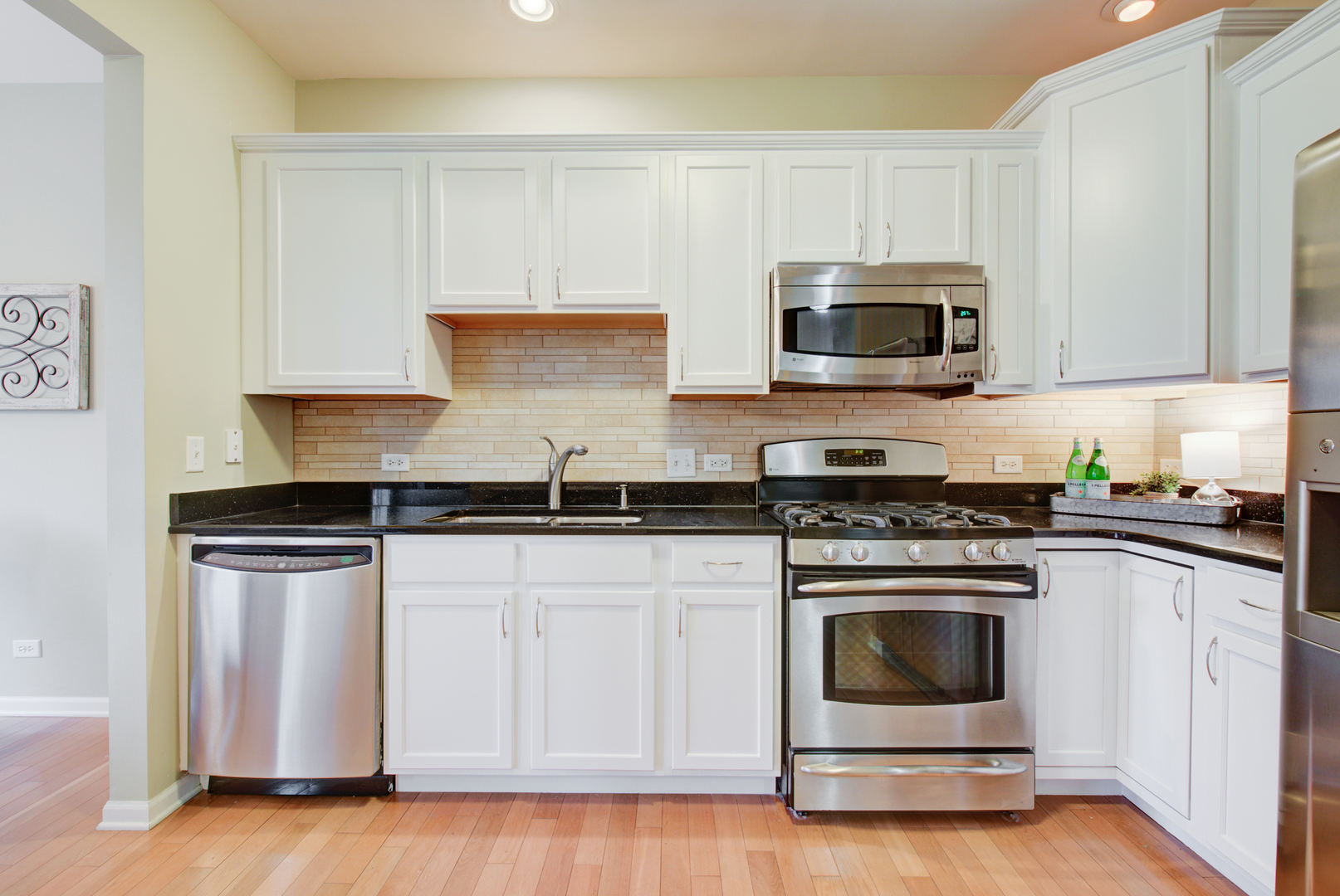 988 Oak Ridge Boulevard Elgin, IL 60120 - Photo 9 of 34 a kitchen with white cabinets stainless steel appliances and sink