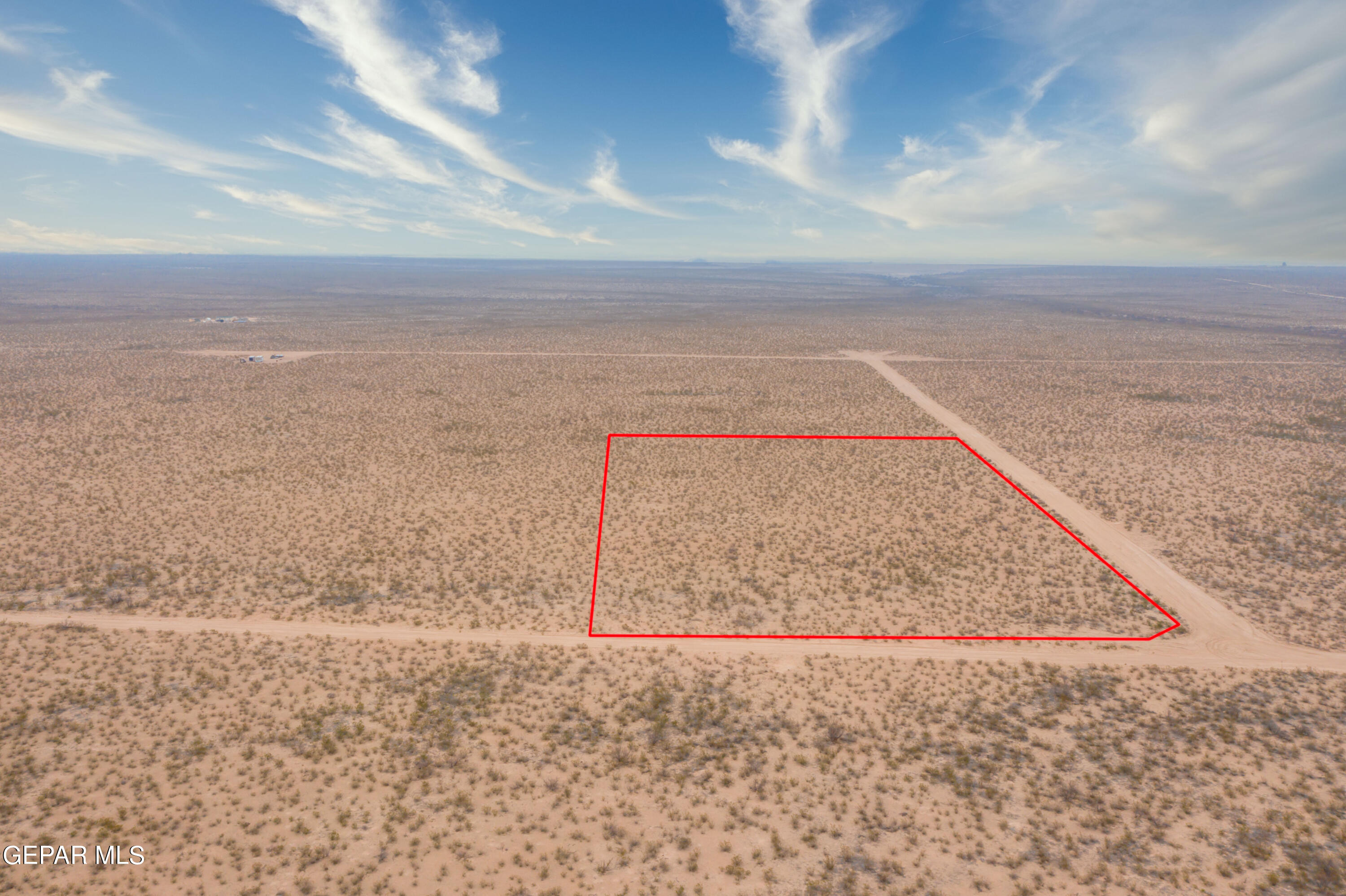 20 Guadalupe Ranch Road Dell City, TX 79847 - Photo 5 of 14 a view of a dry yard with wooden floor