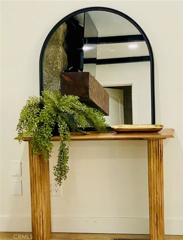 a living room with furniture a fireplace and potted plants