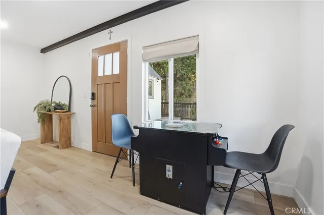 a living room with furniture potted plant and a large window