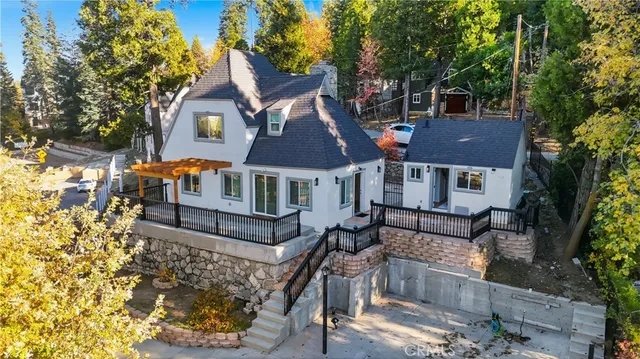 a front view of house with yard and trees in the background