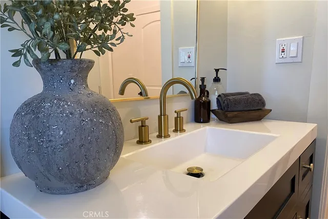 a bathroom with a sink mirror and toilet