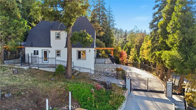 a view of a house with a small yard and potted plants