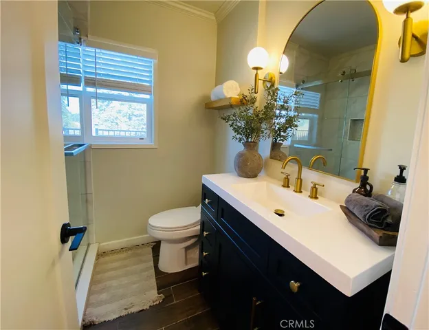 a bedroom with a bed and a table with potted plant