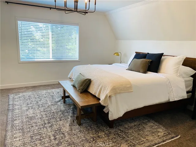 a vase of flowers sitting on a table with a potted plant
