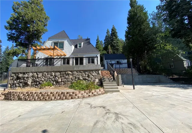 a view of large tree next to a yard