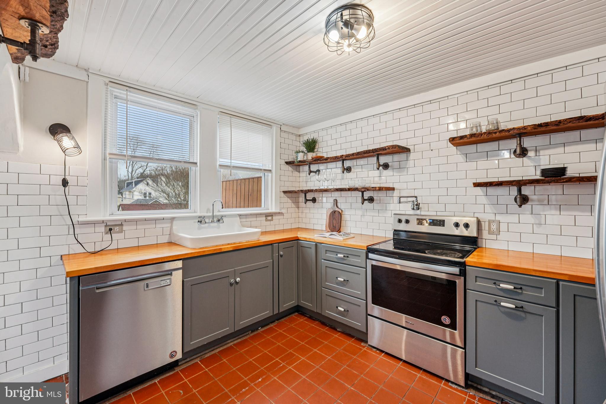 19 Wayne Avenue Springfield, PA 19064 - Photo 13 of 56 a kitchen with stainless steel appliances granite countertop a sink and cabinets