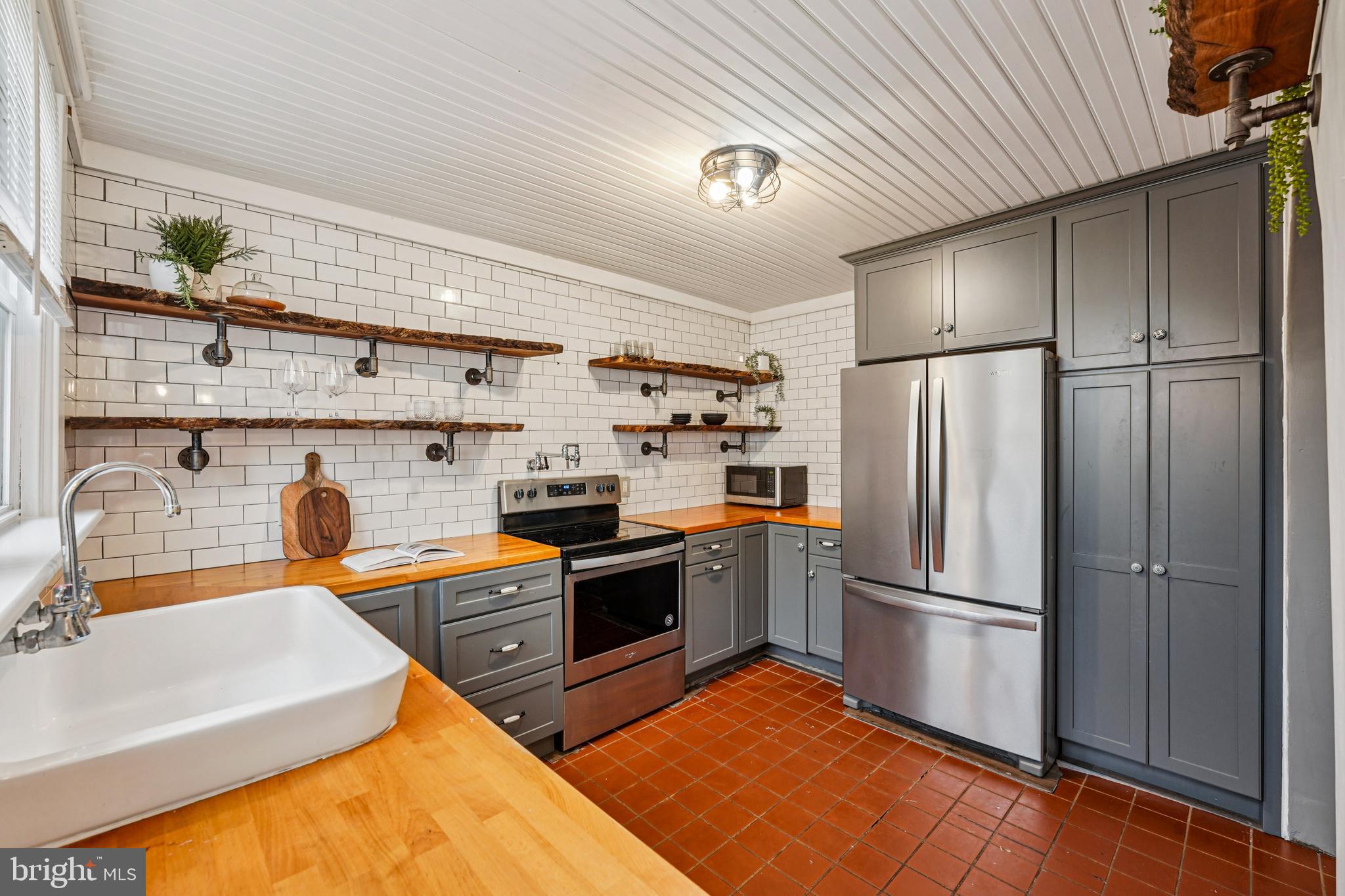 19 Wayne Avenue Springfield, PA 19064 - Photo 14 of 56 a kitchen with stainless steel appliances granite countertop a refrigerator a sink dishwasher a stove and a refrigerator with wooden floor